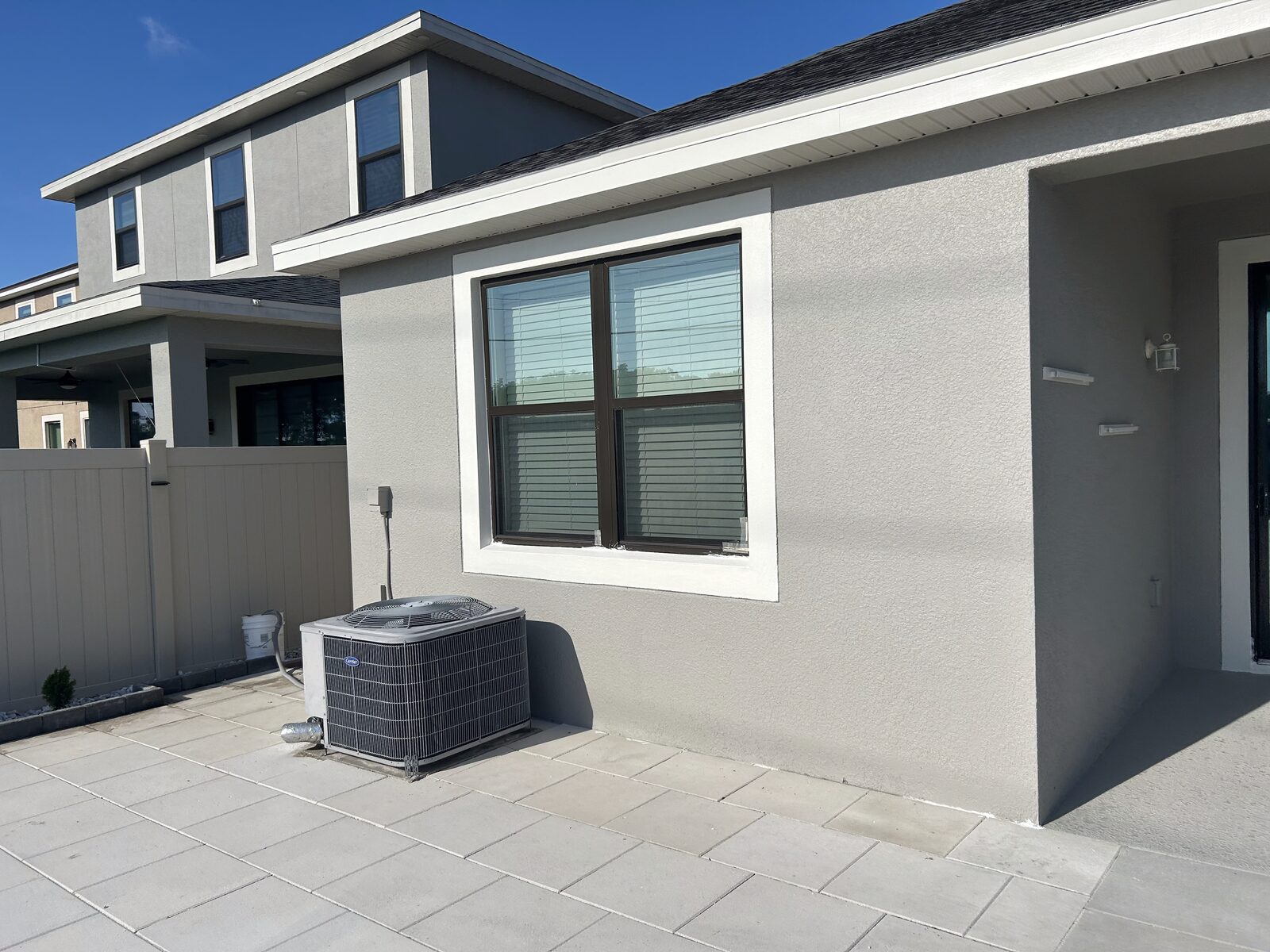 Home exterior side view with fresh stucco paint